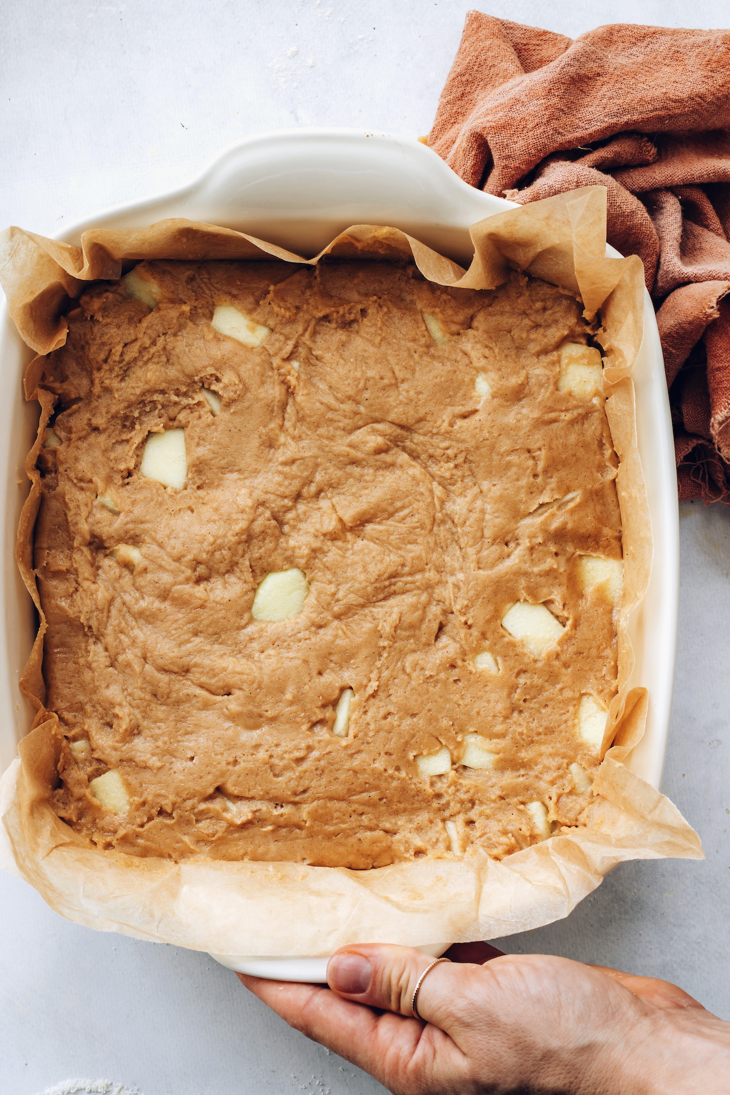 Apple coffee cake batter in a baking dish