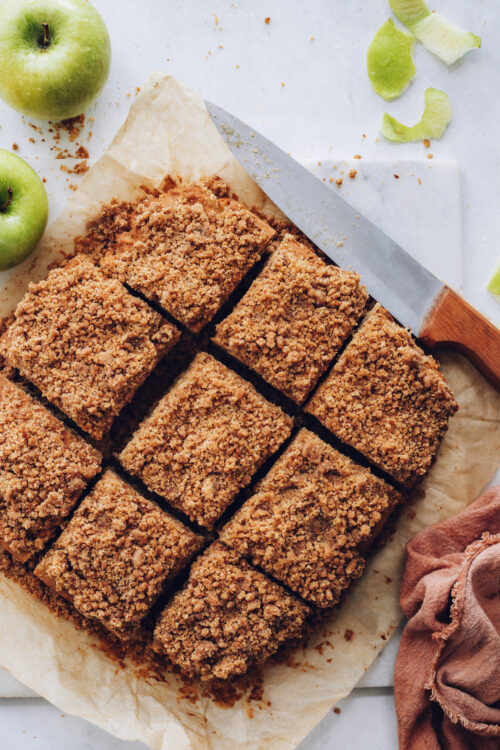 Overhead shot of slices of apple coffee cake with a crumb topping