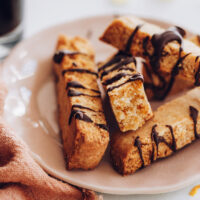 Plate of gluten-free biscotti drizzled with chocolate
