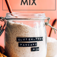 Jar of vegan and gluten-free pancake mix with a spoon in it