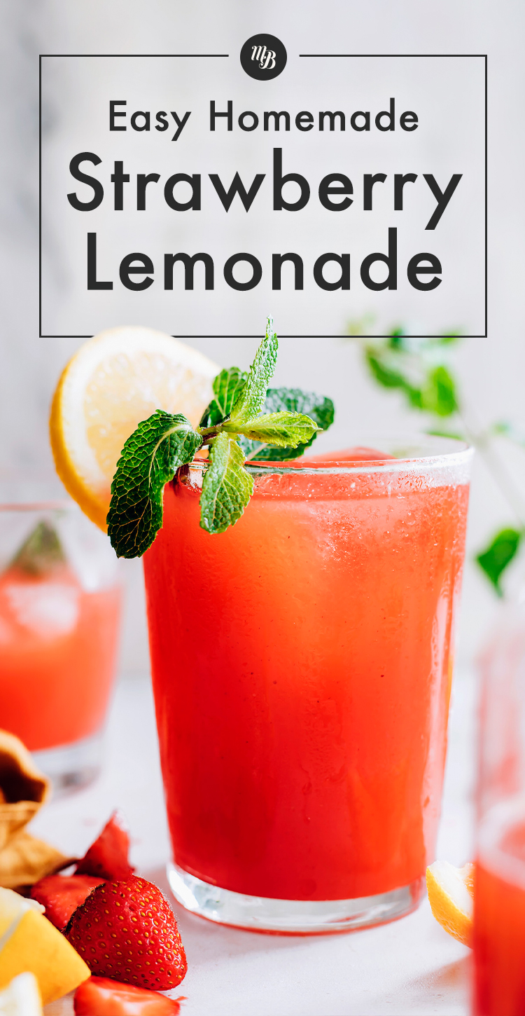 Glass of easy homemade strawberry lemonade with fresh lemon and mint on the side