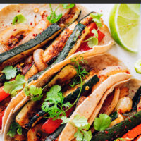 Plate of vegan and gluten-free bell pepper and zucchini tacos
