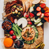 Wooden platter overflowing with vegan appetizers