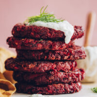 Stack of beet fritters with dill yogurt sauce