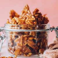 Jar filled with pieces of almond brittle