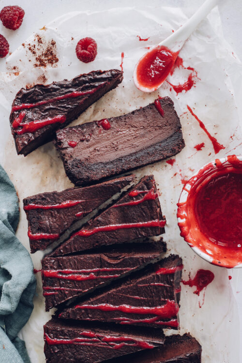 Vegan chocolate cheesecake drizzled with a raspberry sauce