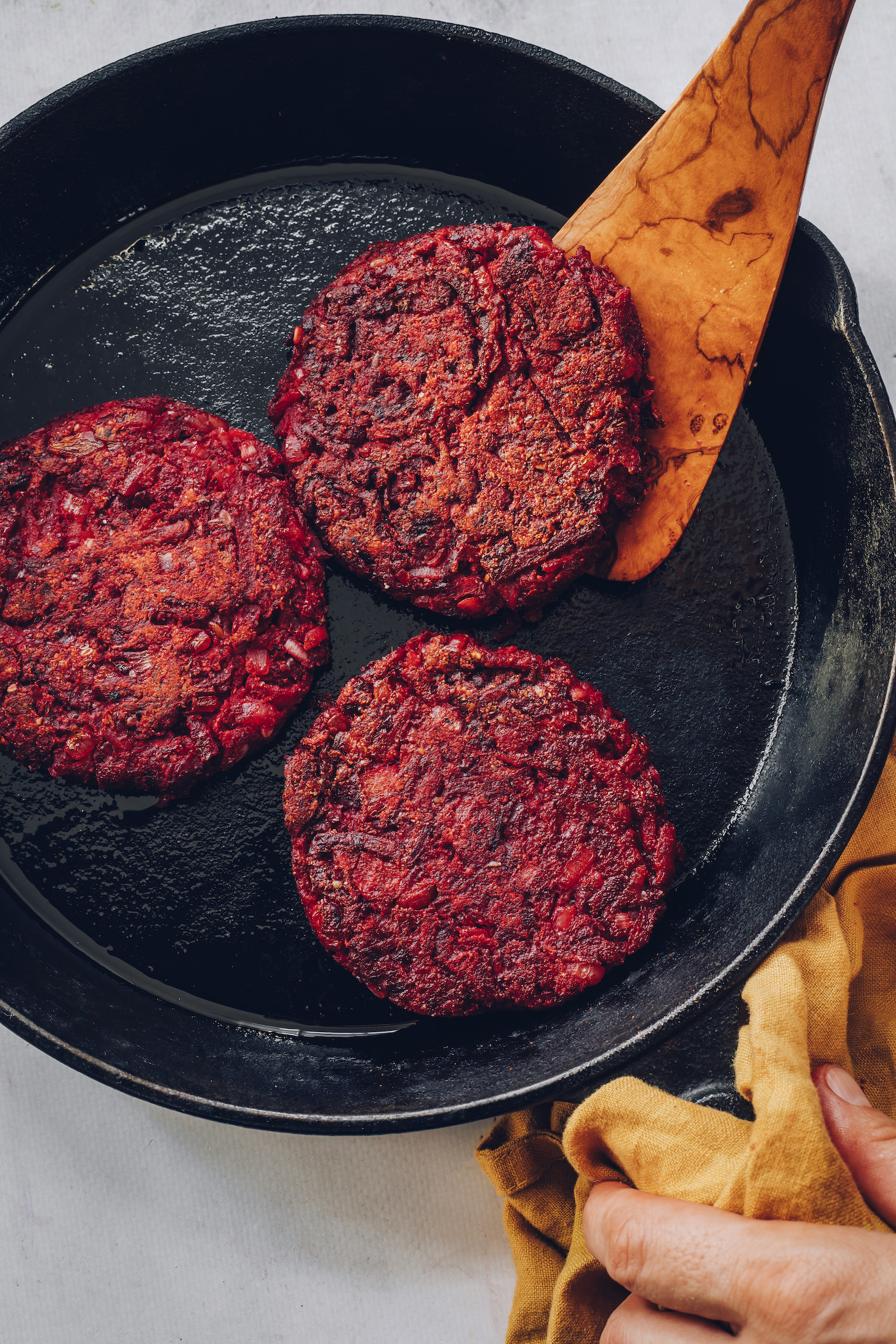 Cooking beet fritters in a cast iron skillet