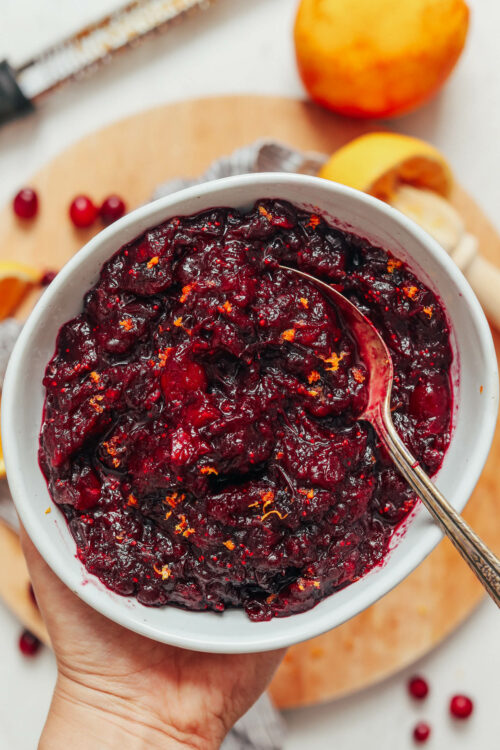 Spoon in a bowl of homemade orange cranberry sauce