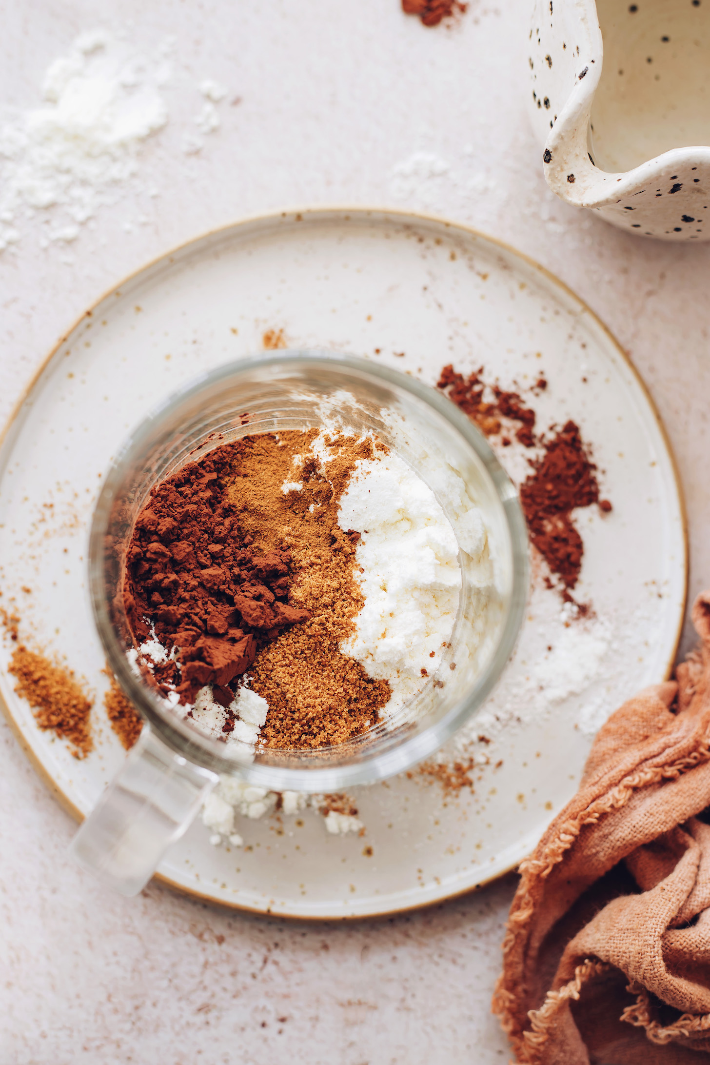 Mug with coconut milk powder, coconut sugar, cocoa powder, and cinnamon