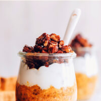 Jar of vegan and gluten-free pumpkin pie overnight oats with coconut yogurt and granola on top
