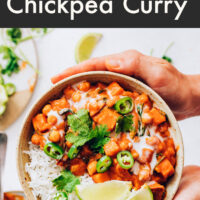 Hands holding a bowl of vegan and gluten-free instant pot-friendly roasted red pepper chickpea curry