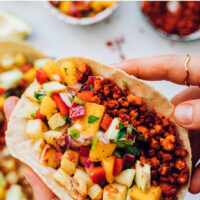 Hands holding a vegan chorizo breakfast taco