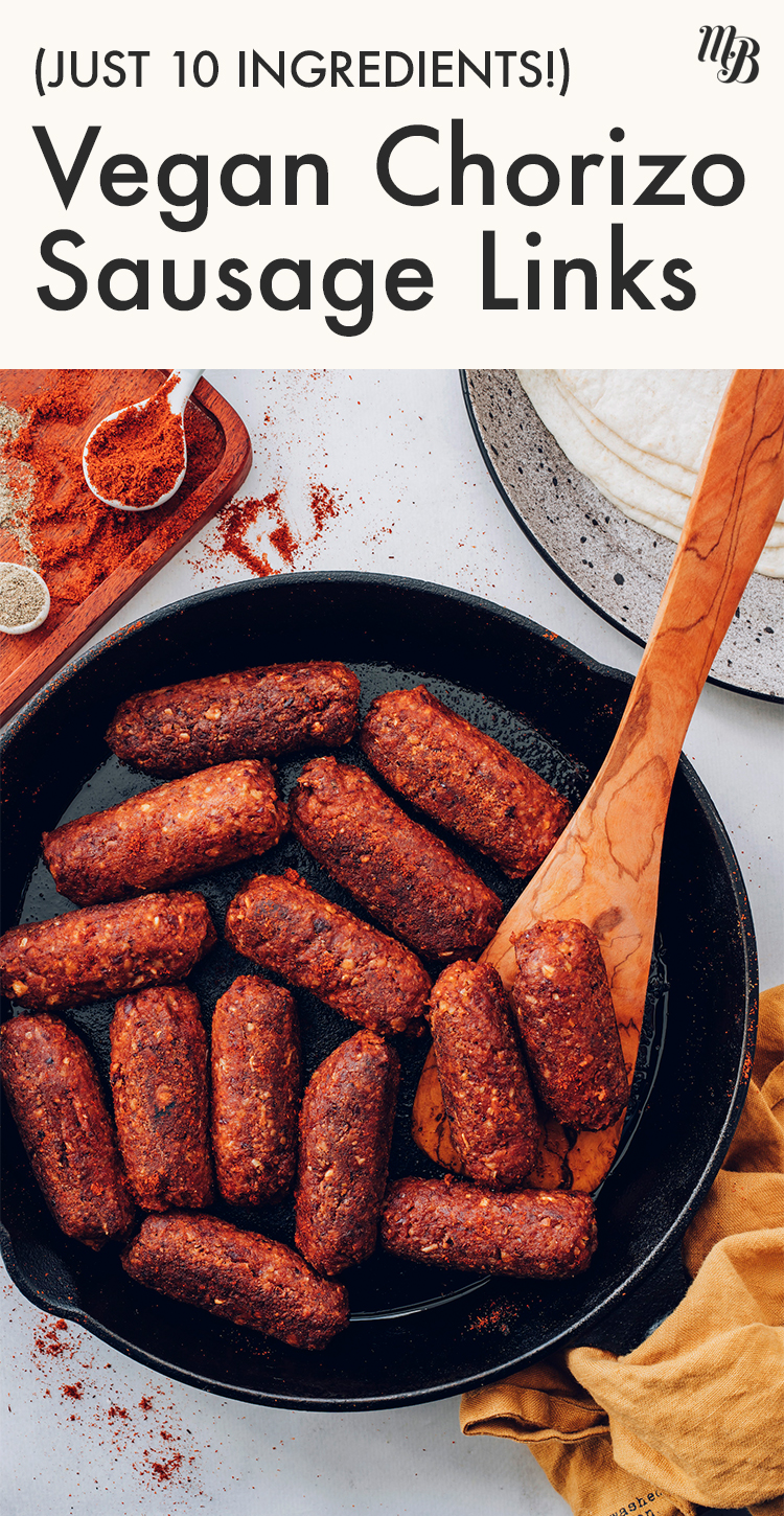 Cast iron skillet of vegan and gluten-free chorizo sausage links with a wooden spoon in it
