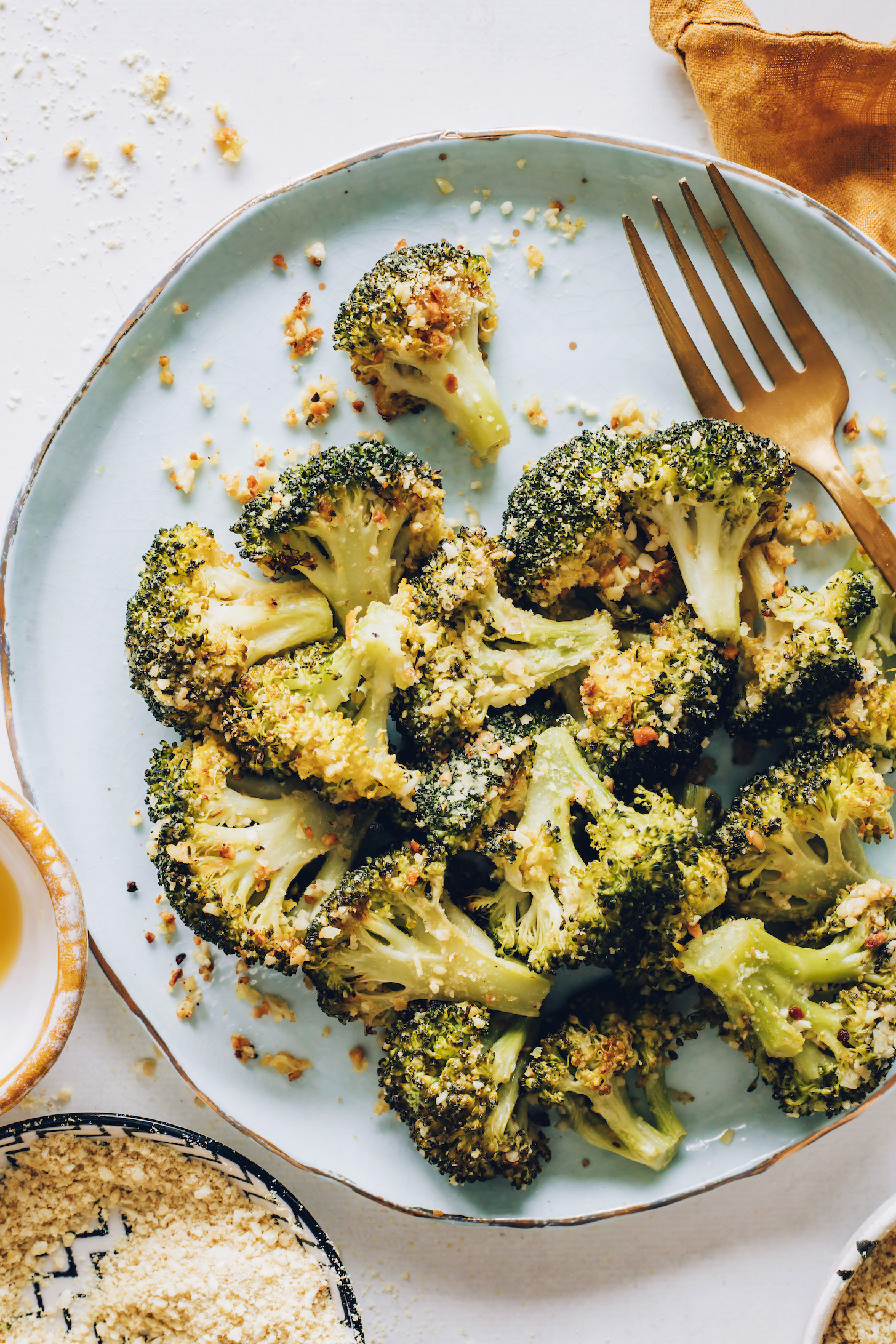 Plate of perfect roasted broccoli with vegan parmesan