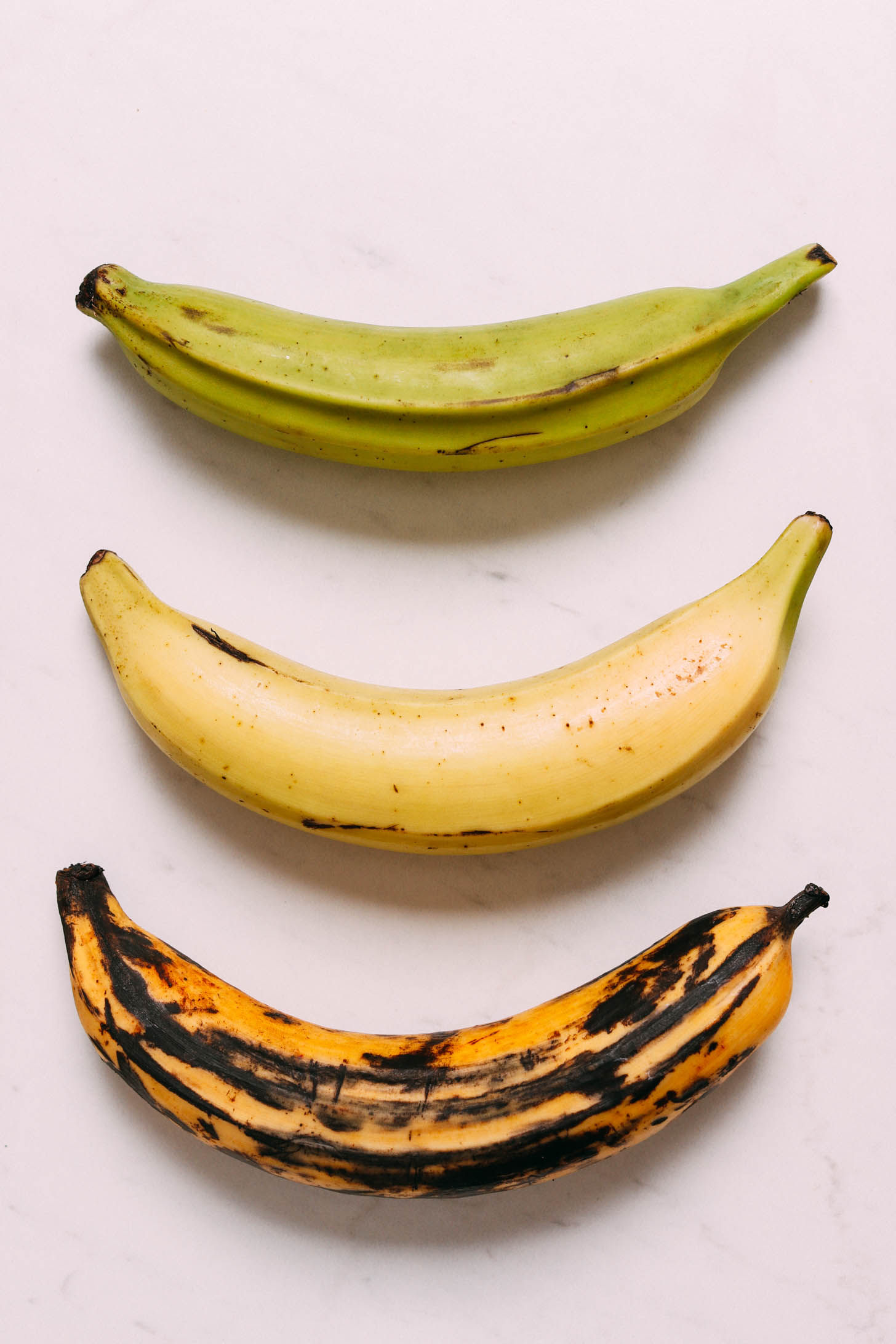 Showing one green, one yellow, and one ripe plantain