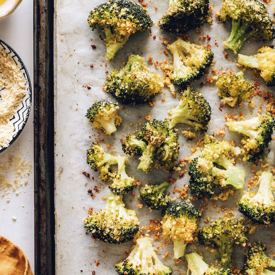 Close up of oven roasted broccoli on a baking sheet