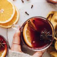 Hands holding a mug of non alcoholic mulled "wine"