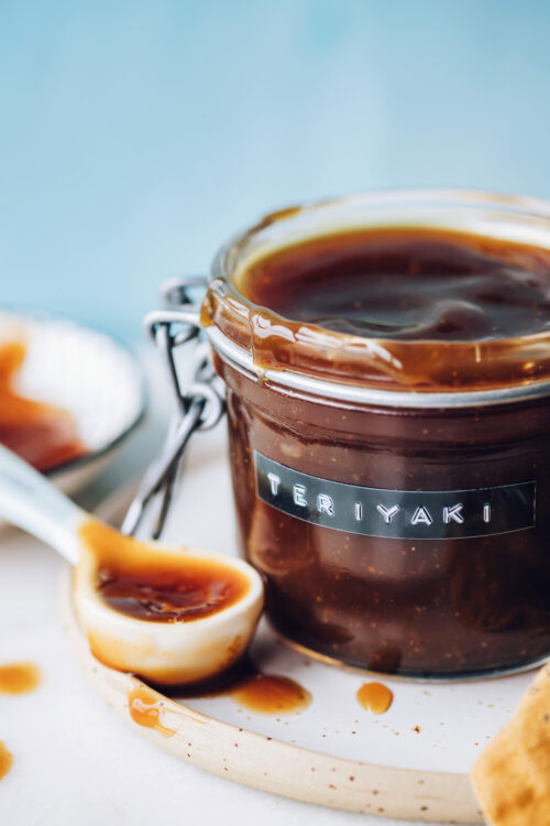 Spoon and jar filled with homemade gluten-free teriyaki sauce