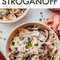 Holding a bowl filled with our creamy vegan mushroom stroganoff recipe