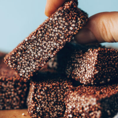 Picking up a chocolate amaranth bar from a stack