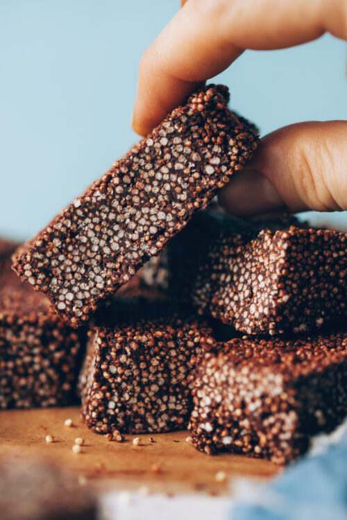 Picking up a chocolate amaranth bar from a stack