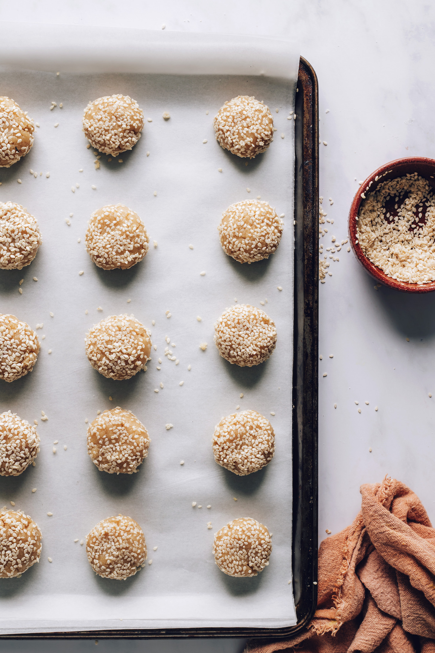 Unbaked tahini cookies on a baking sheet