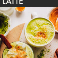 Mugs of golden matcha lattes with turmeric sprinkled on top