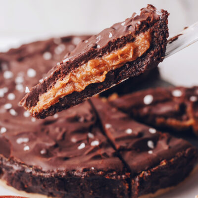 Holding up a slice of our salted caramel chocolate ganache tart