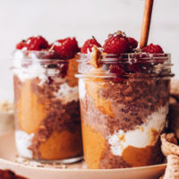 Two jars of chocolate overnight oats with fresh raspberries