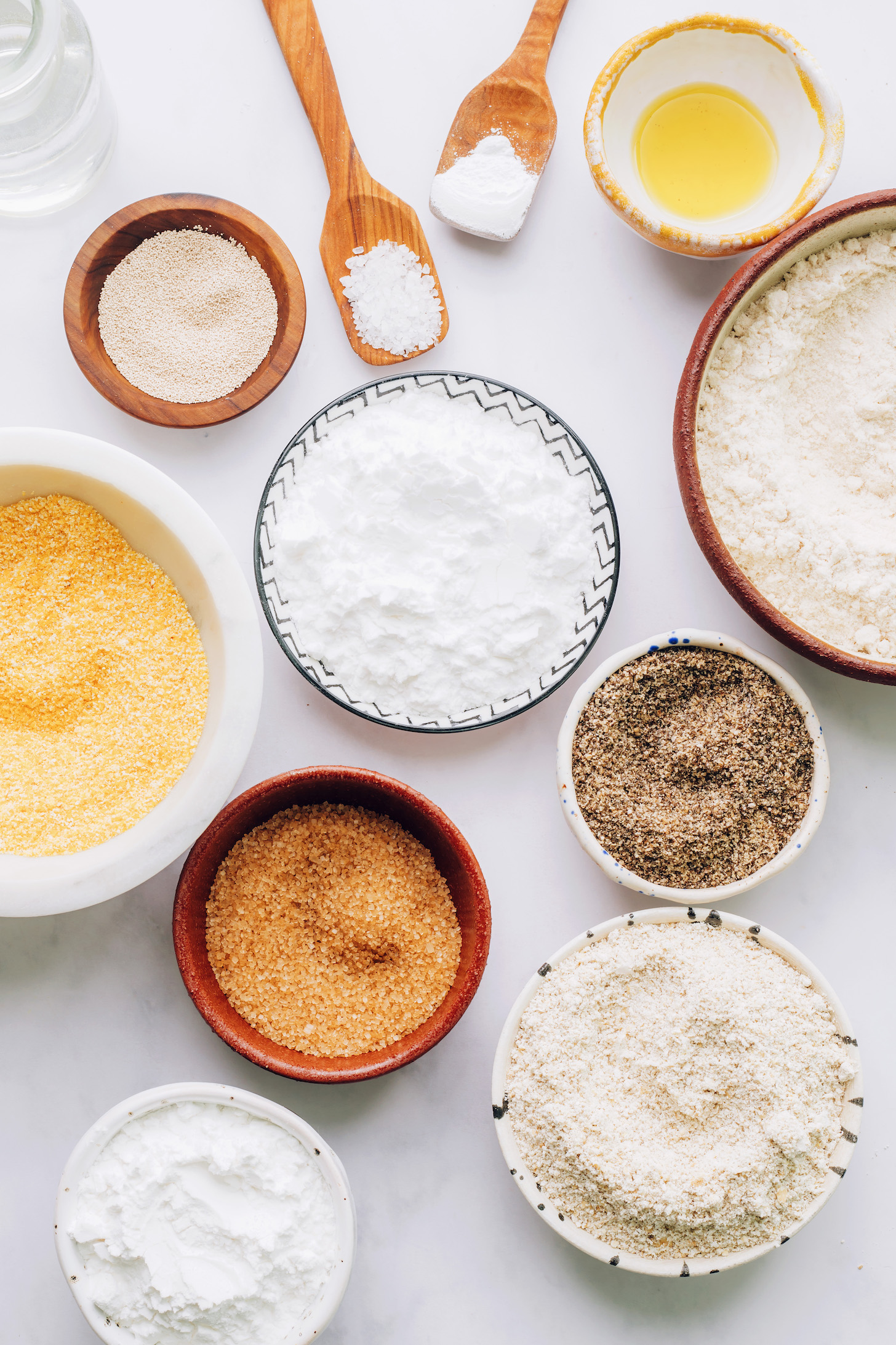 Yeast salt baking powder, avocado oil, brown rice flour, tapioca flour, potato starch, oat flour, cornmeal, ground chia seeds, and cane sugar