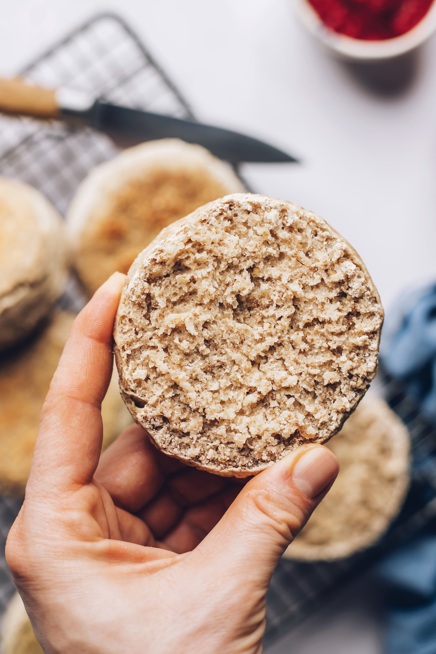 Hand-held sliced ​​gluten-free English muffin to show the inner texture