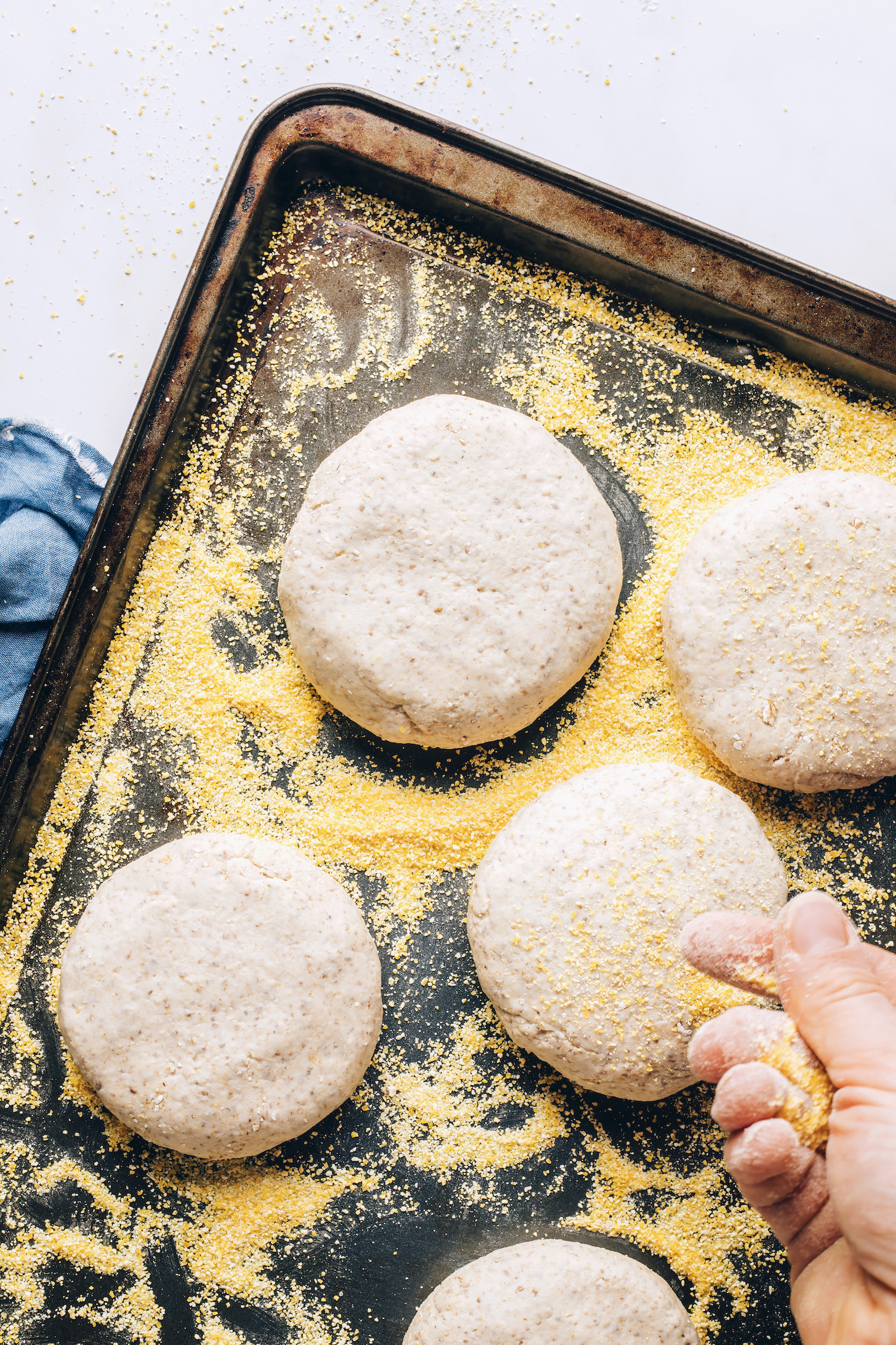 Sprinkling cornmeal over gluten-free English muffins