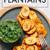 Plate of roasted plantains with green chutney on the side