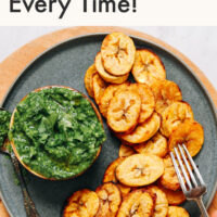 Plate of roasted plantains with green chutney on the side