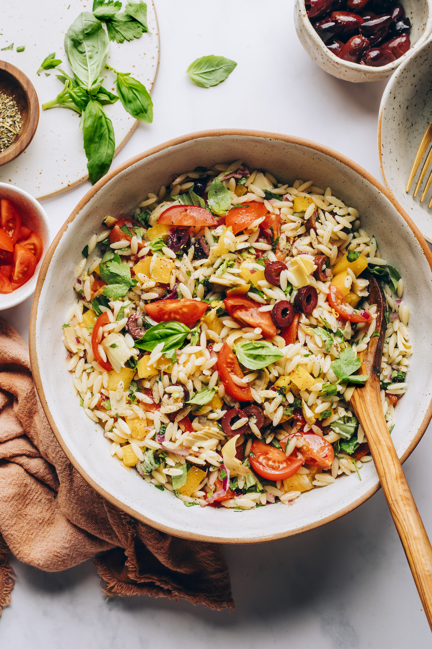 Large bowl filled with a vibrant Mediterranean-inspired orzo salad
