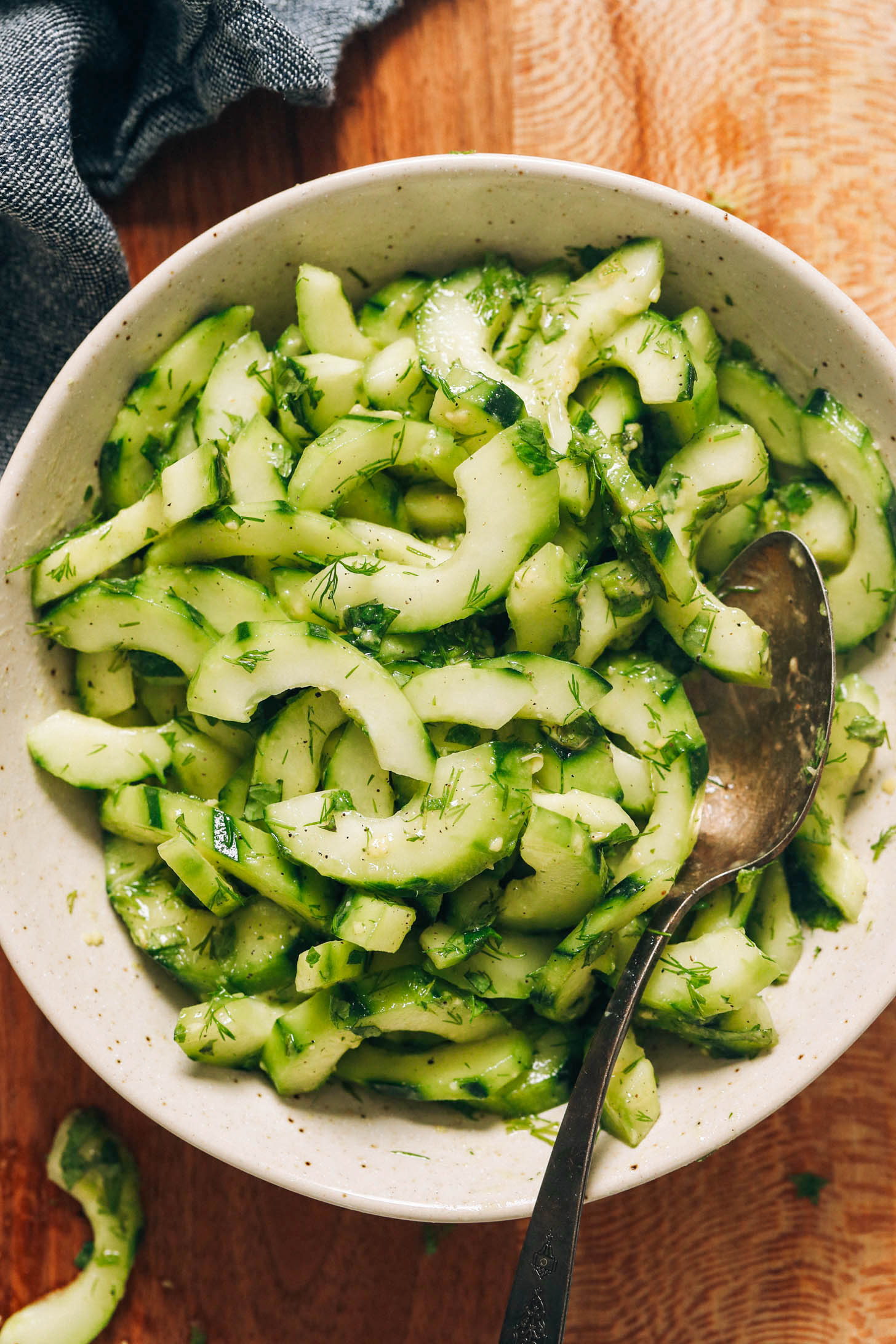 Bowl of cucumber salad with fresh dill and mint
