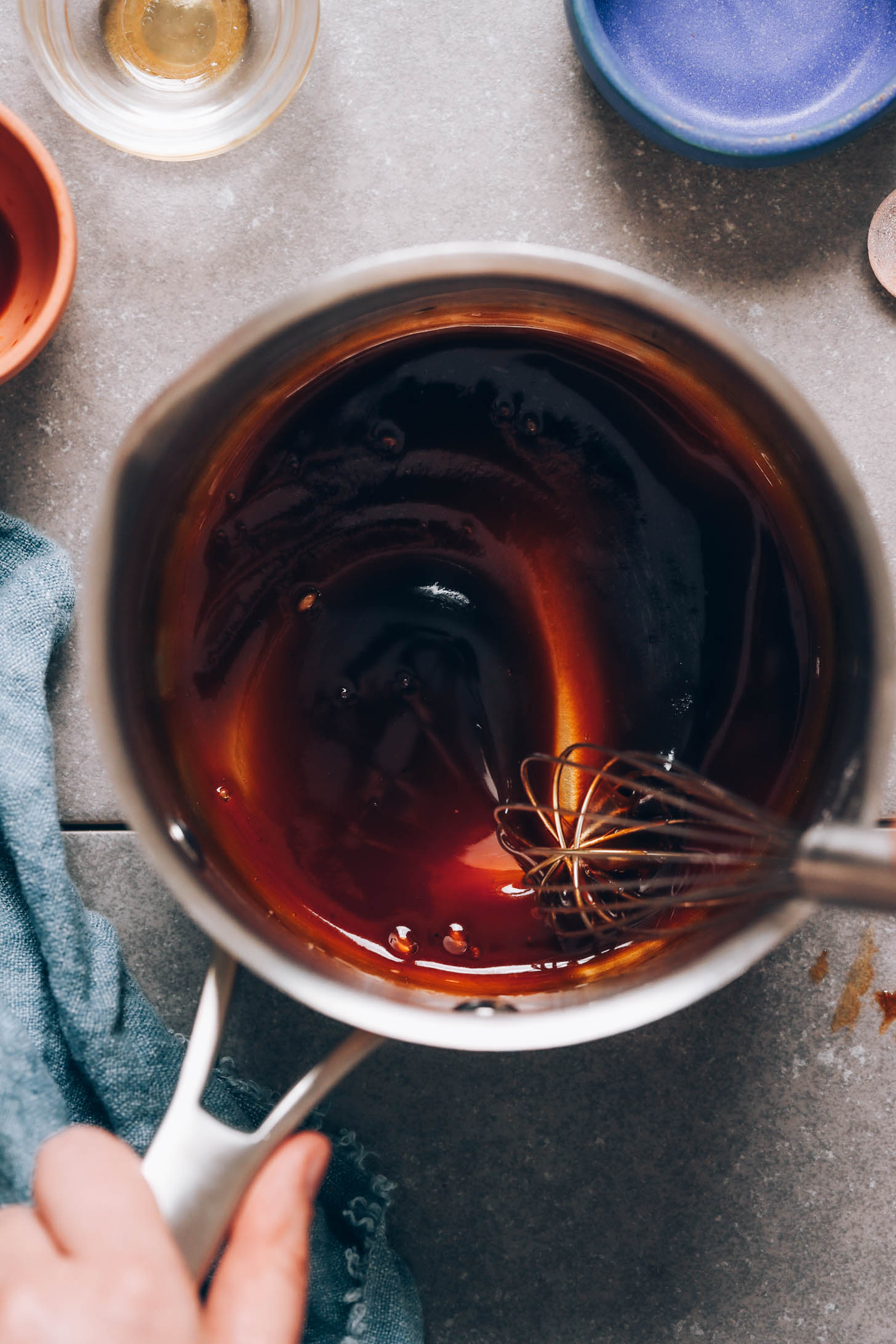 Stirring teriyaki glaze in a saucepan
