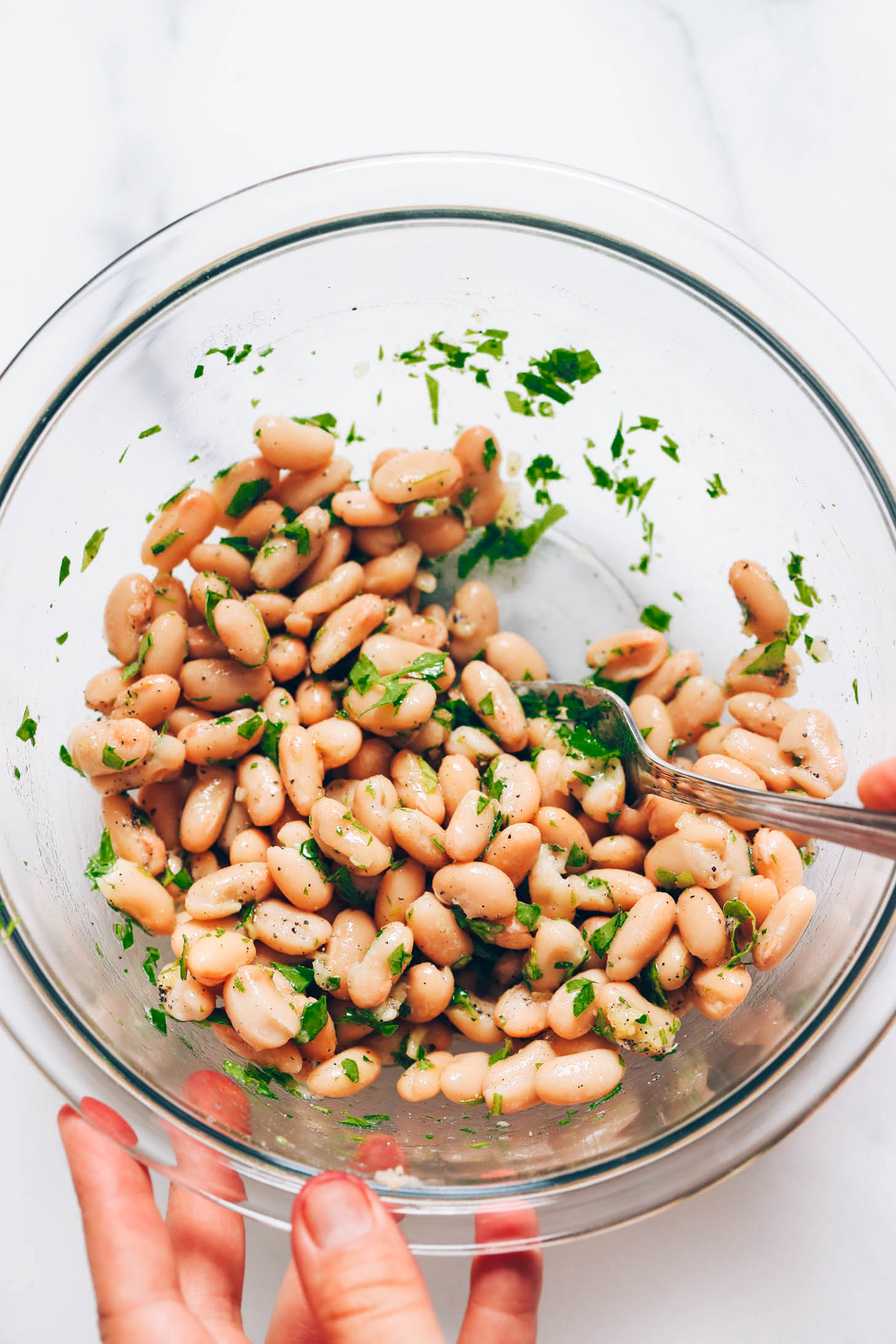 White beans mixed with garlic, lemon juice, olive oil, salt, pepper, and parsley