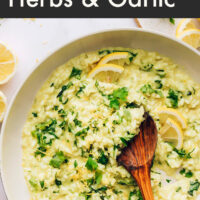 Bowl of vegan and gluten-free lemony risotto with fresh herbs and garlic