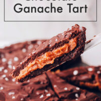 Slice of vegan and gluten-free salted caramel chocolate ganache tart