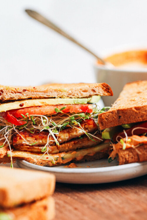 Plate with a smoky tempeh and chipotle hummus sandwich