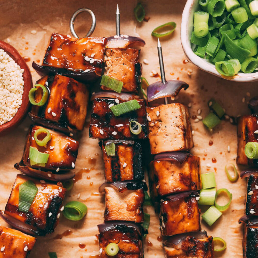 Close up shot of grilled tofu skewers brushed with a teriyaki marinade