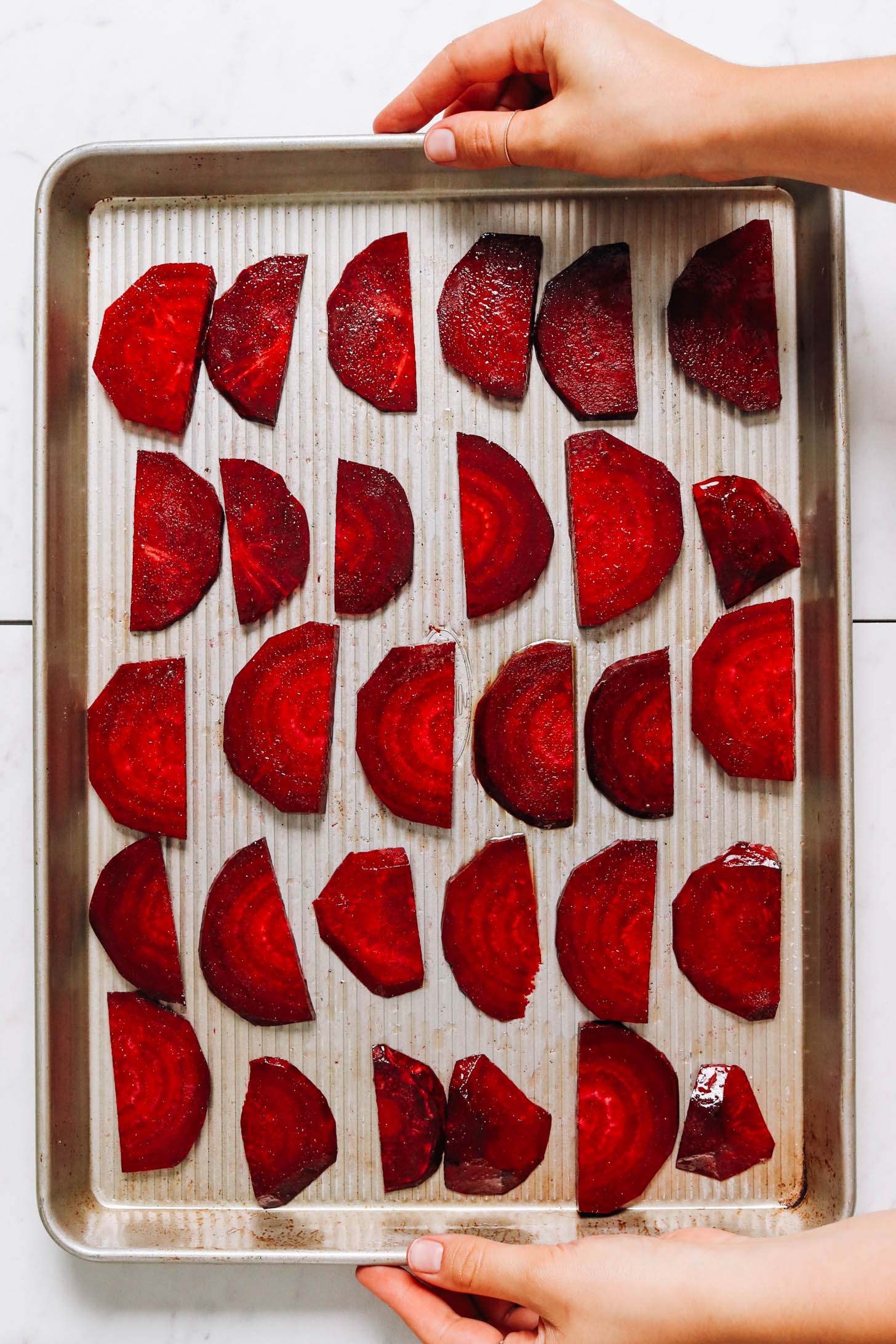 Thinly sliced beets on a baking sheet