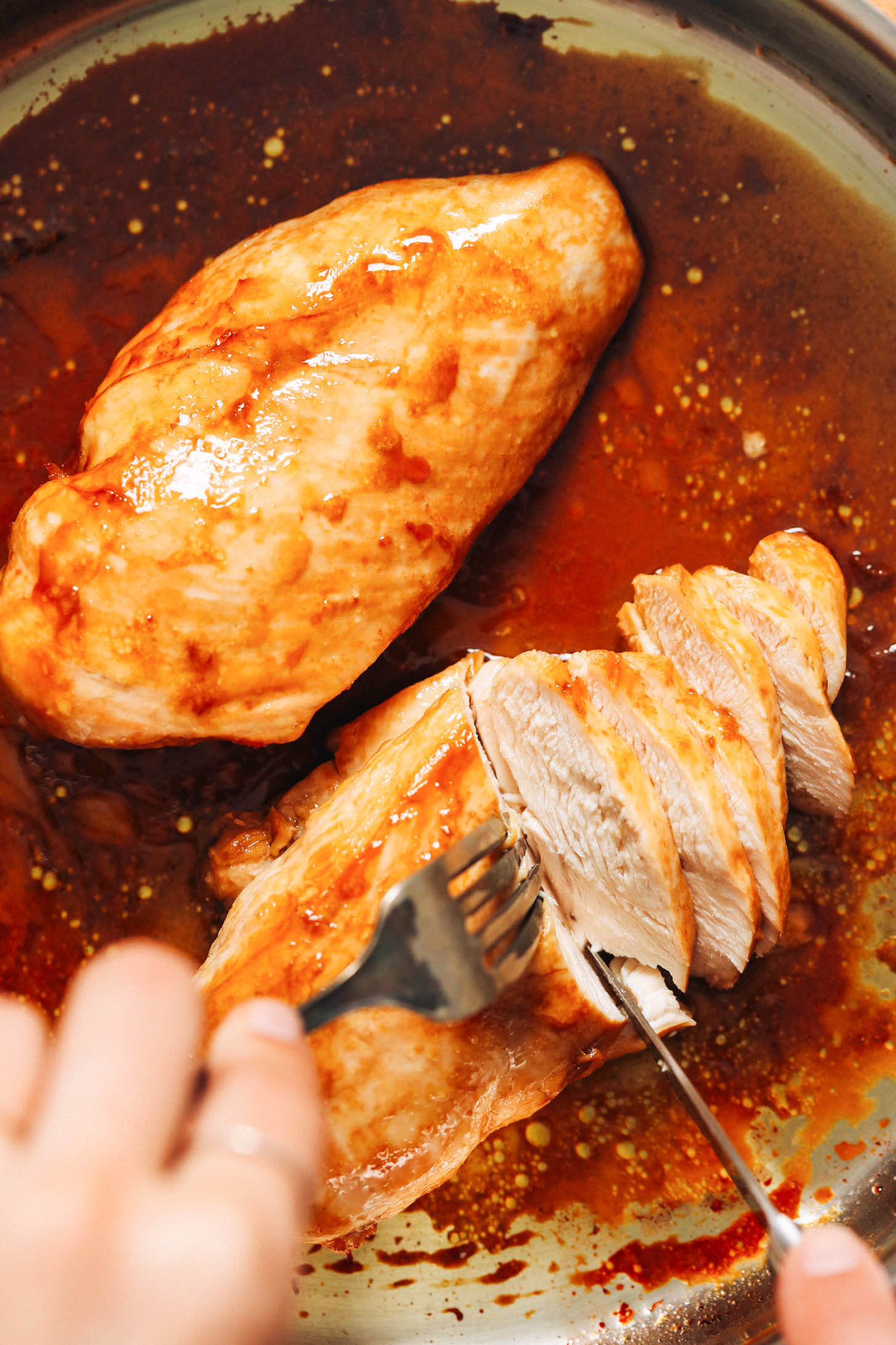 Slicing into a pan seared baked chicken breast