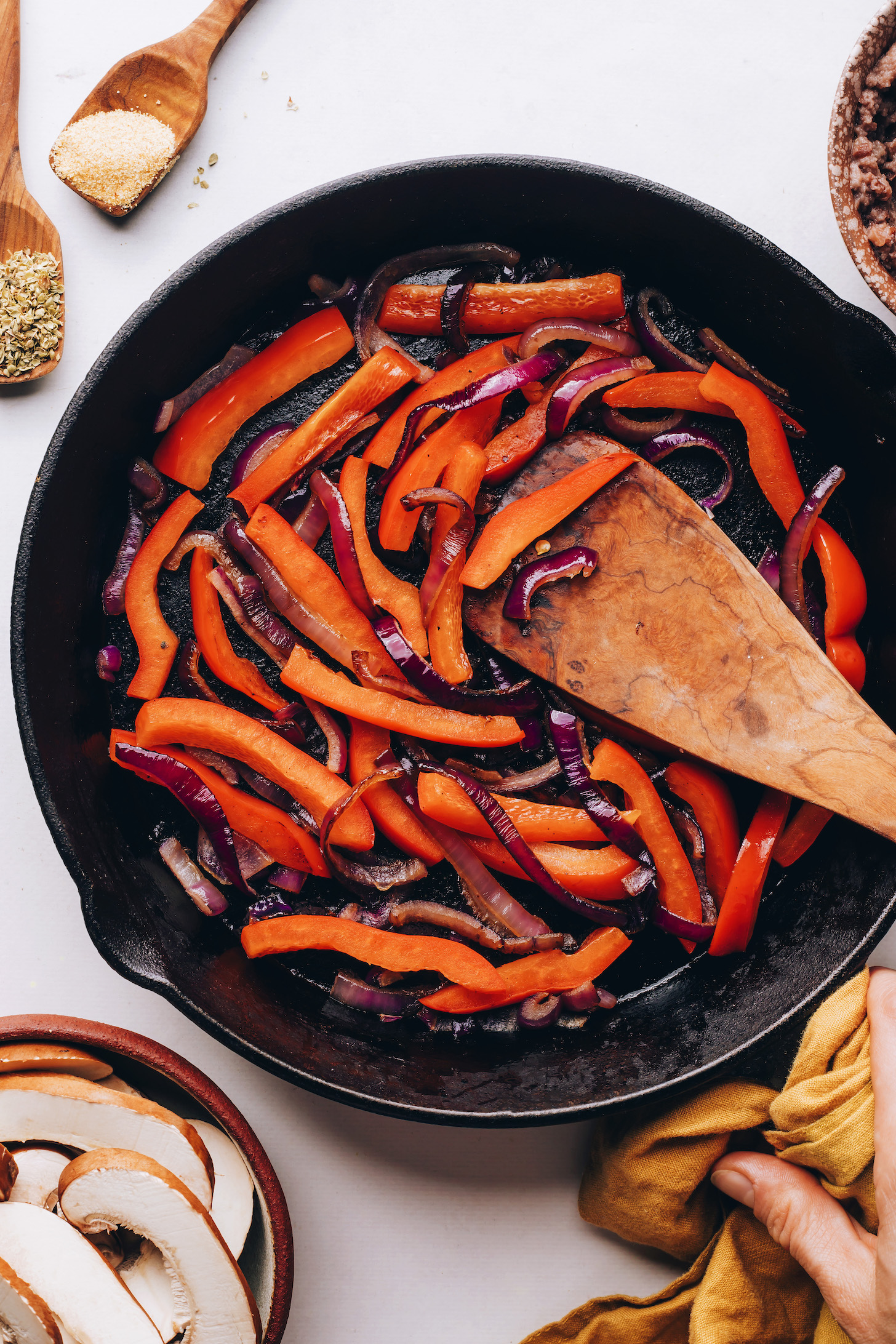 Sautéed red bell pepper and red onion in a cast iron skillet