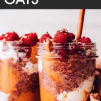 A glass of vegan և gluten-free fall chocolate night oats with raspberries