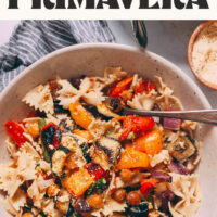 Holding a bowl of vegan pasta primavera made with roasted veggies