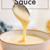 Spoon scooping easy vegan hollandaise sauce out of a ramekin