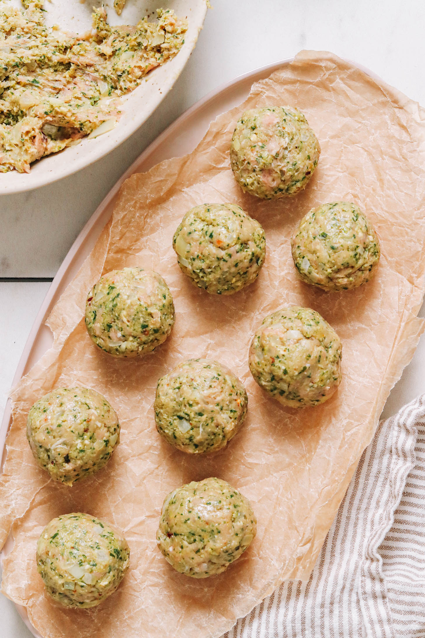 Pesto turkey meatballs on a plate before cooking