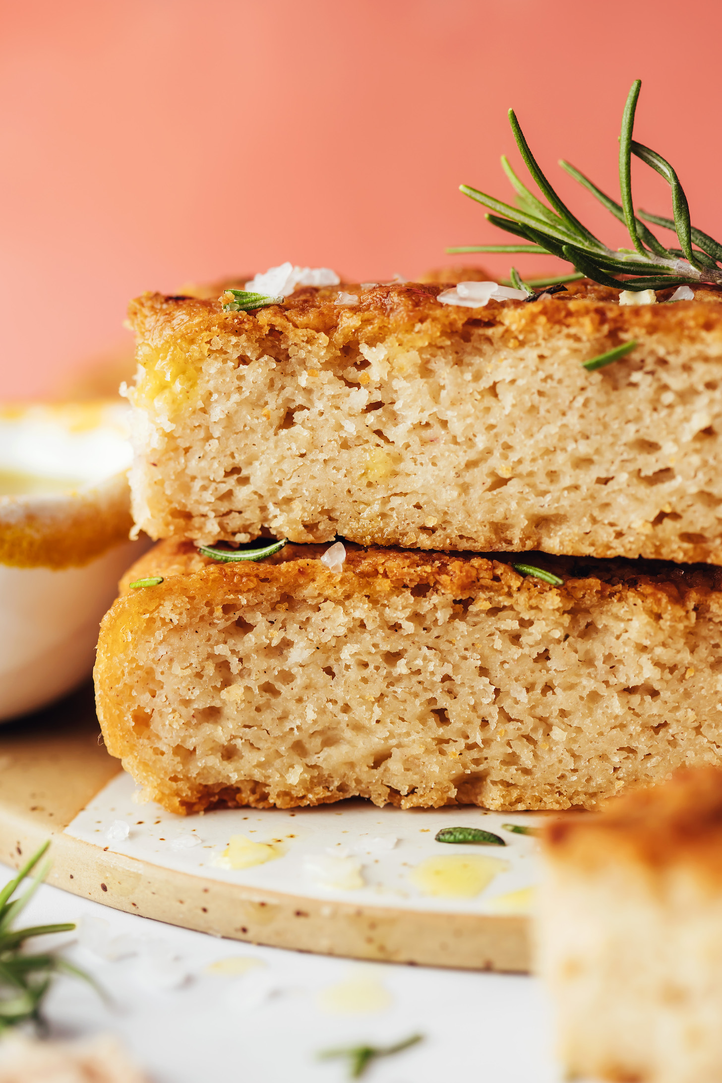 Stack of two pieces of gluten-free focaccia bread topped with rosemary